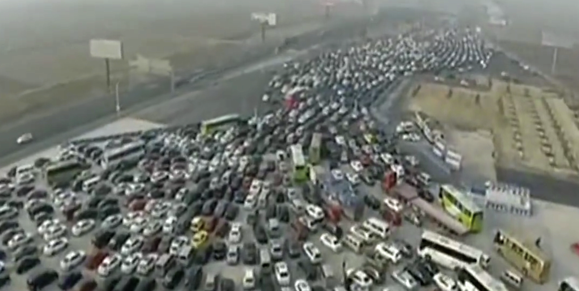 A chaotic scene of multiple lanes of traffic converging